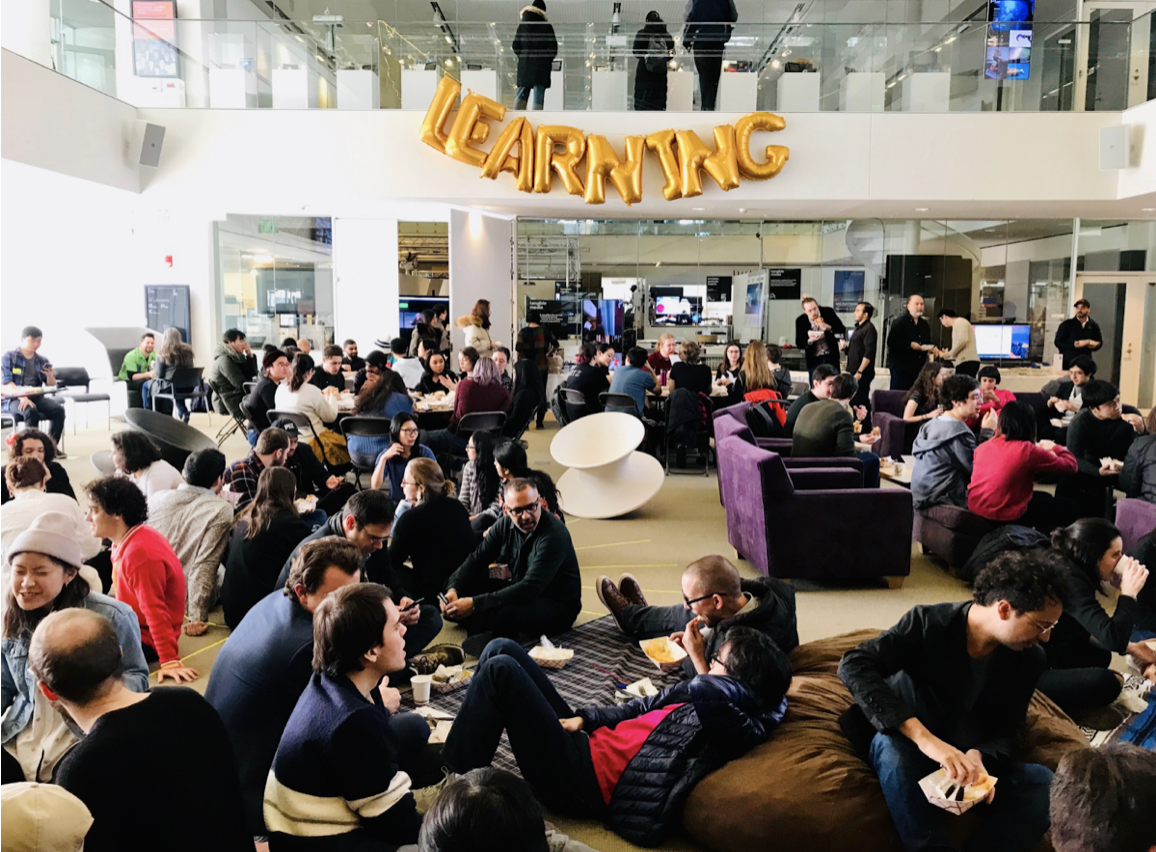 Festival of Learning at MIT Media Lab — crowd gathered under LEARNING balloon letters